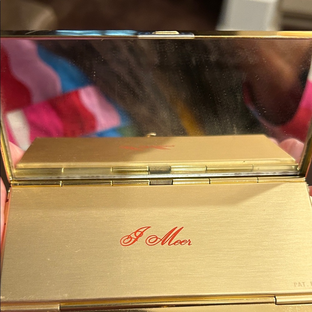 Gold Compact Mirror with Red 'J Meer' Script Logo